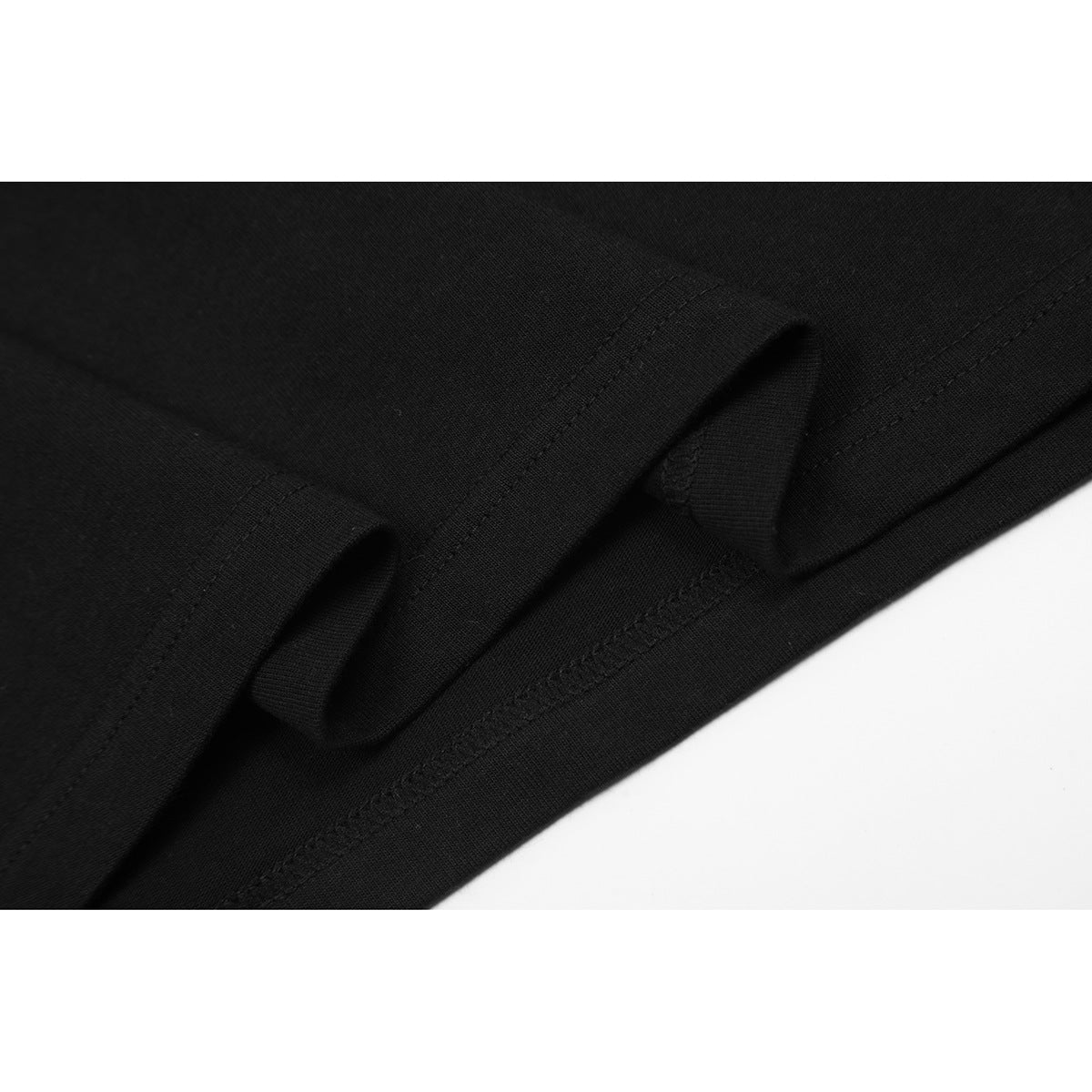 Close-up of the black T-shirt’s stitched lower hem.