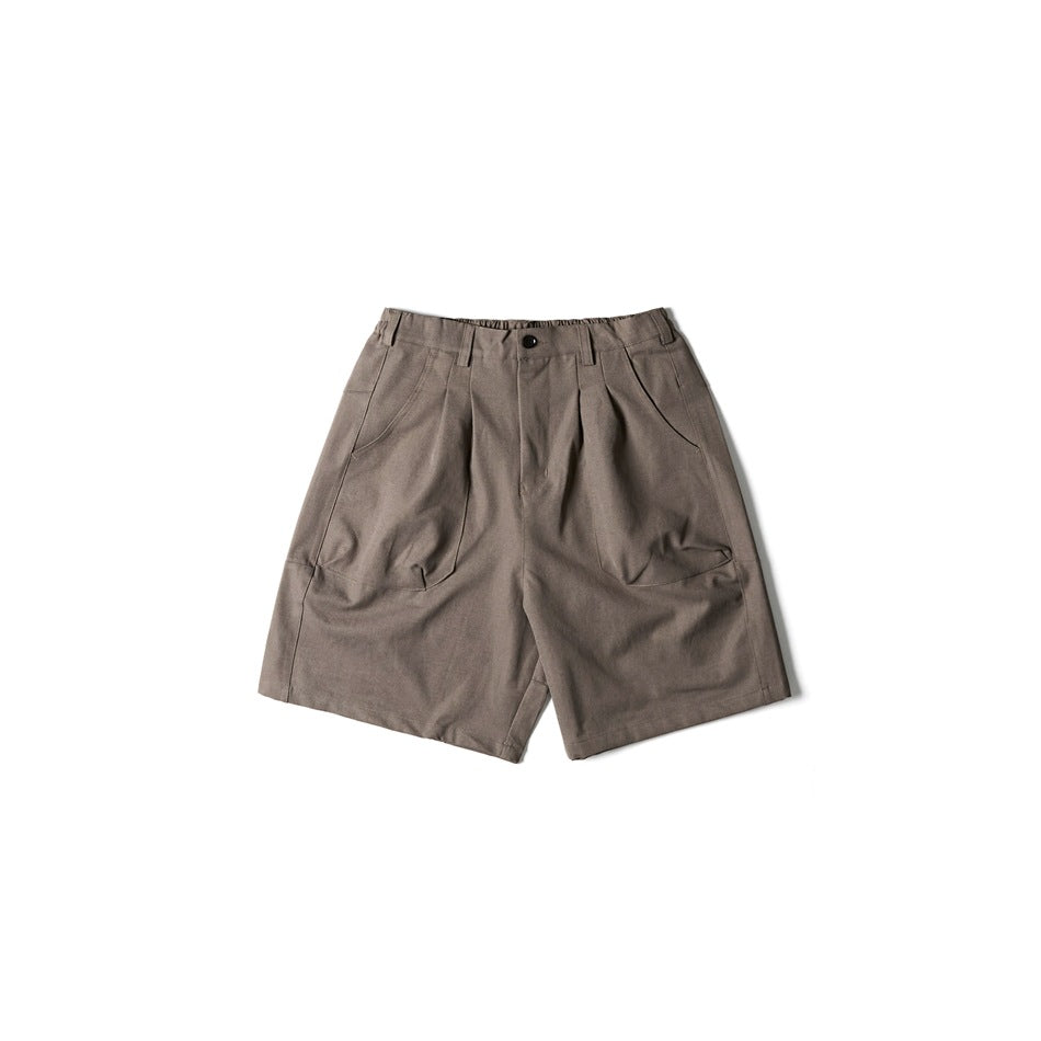 Taupe-brown pleated wide-leg shorts with button front, elastic waistband and slanted pockets, flat lay