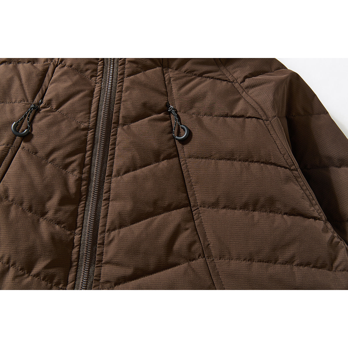 Close-up of a brown quilted jacket’s front zipper and chest drawcords with hooks.