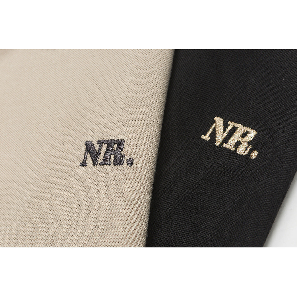 Close-up of NB embroidery on beige and black polo shirt fabric.