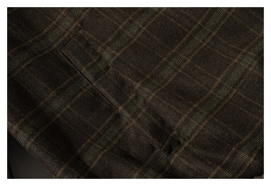 Close-up of a pocket on a brown plaid garment.