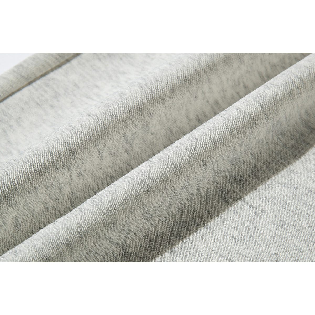 Close-up showing the texture and mottled gray pattern of the pants fabric.