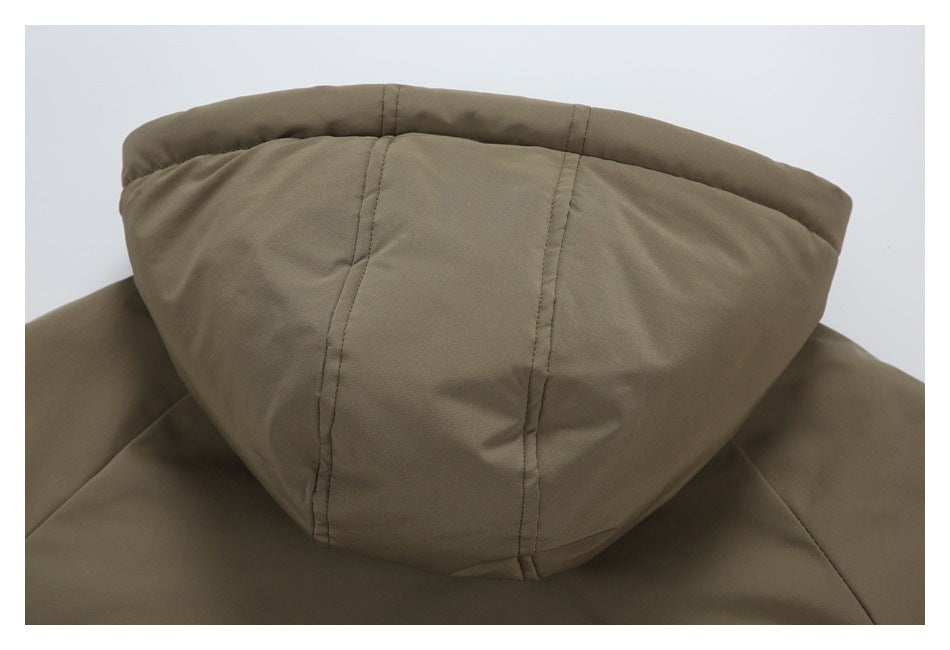 Close-up of the back of an olive-brown jacket hood with stitched panels.