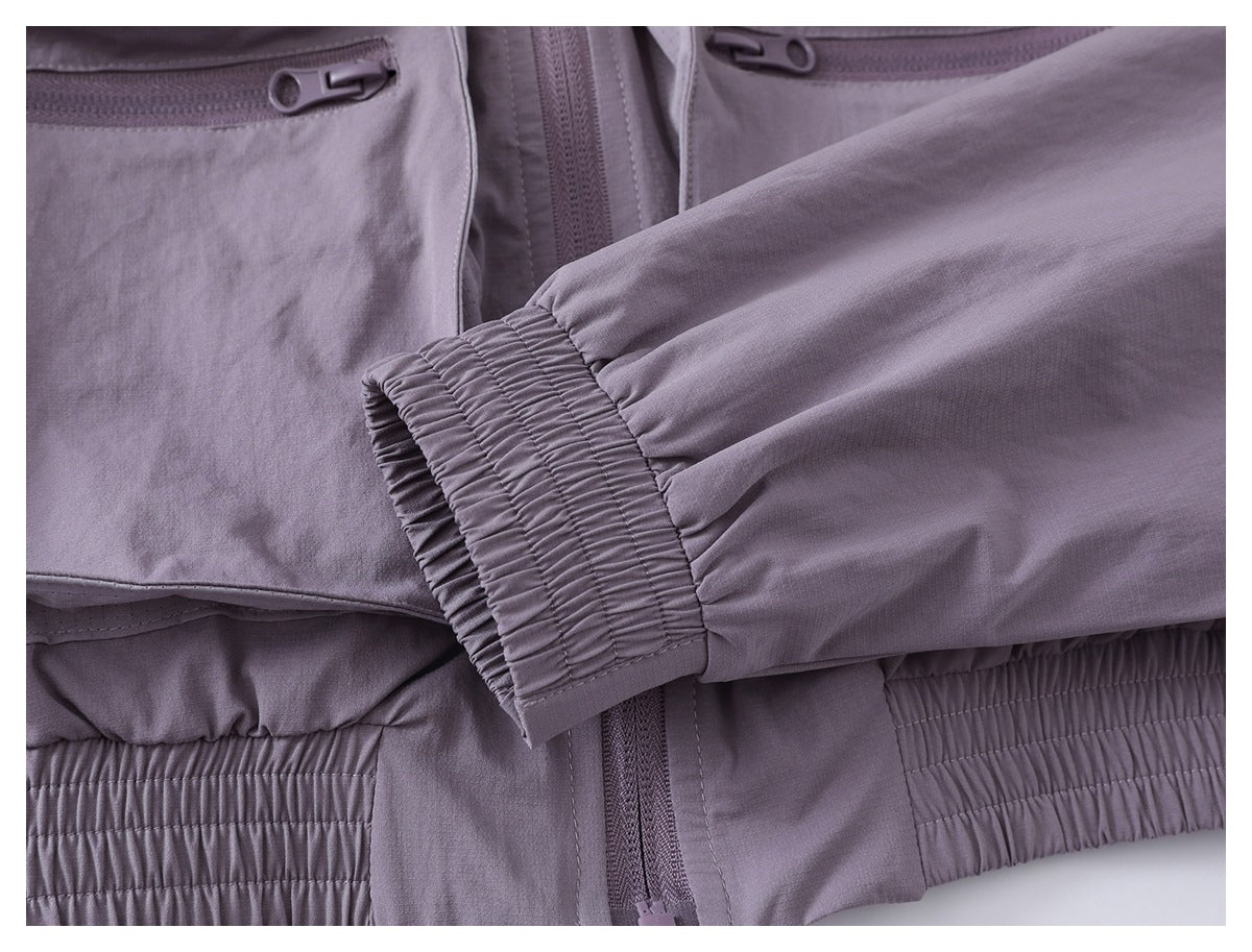 Close-up of the lavender jacket sleeve and gathered elastic cuff, with the front pockets and hem partly visible.