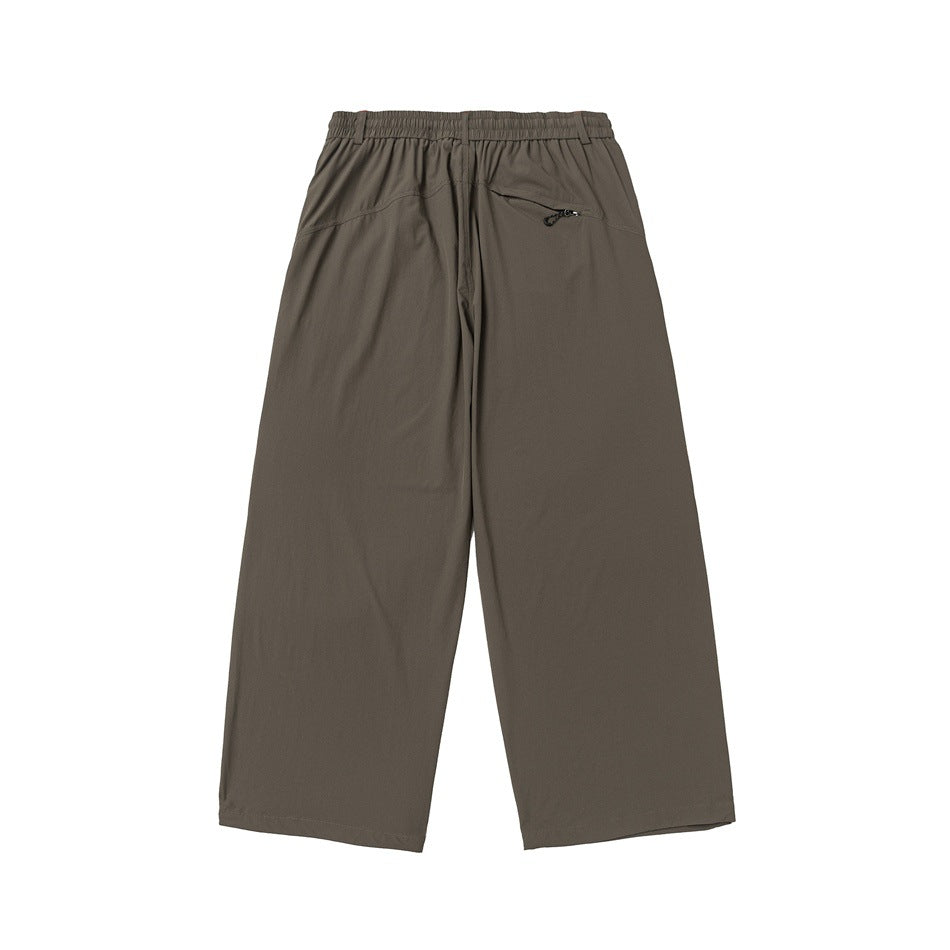Back view of olive-gray wide-leg trousers with an elastic waistband and a small zip pocket.