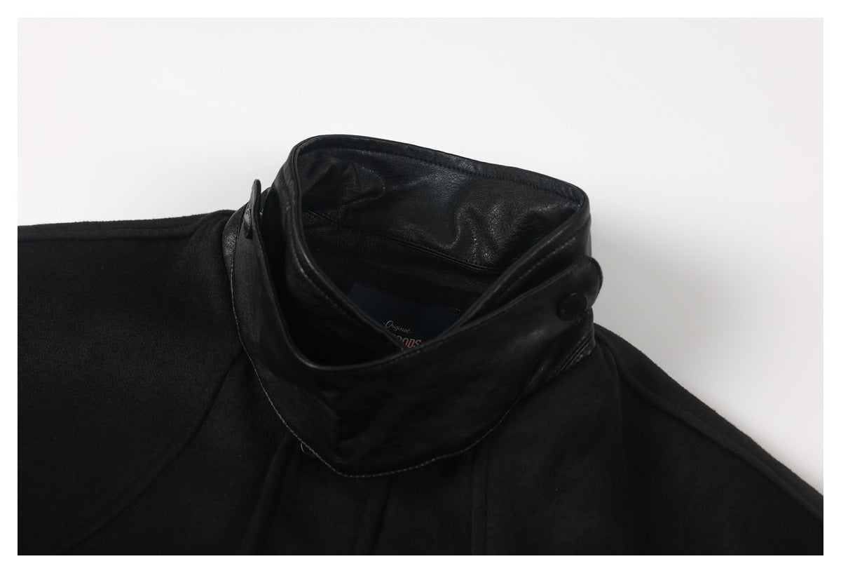 Close-up of the black jacket's raised collar, showing a glossy inner facing and button.