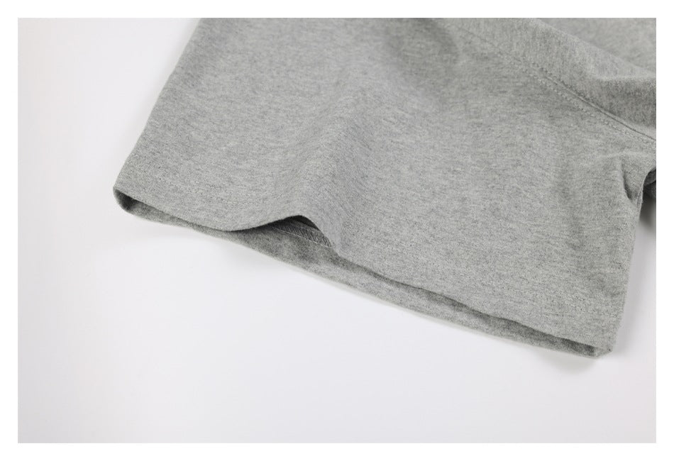 Close-up of a gray short-sleeve garment showing the sleeve edge and stitching.