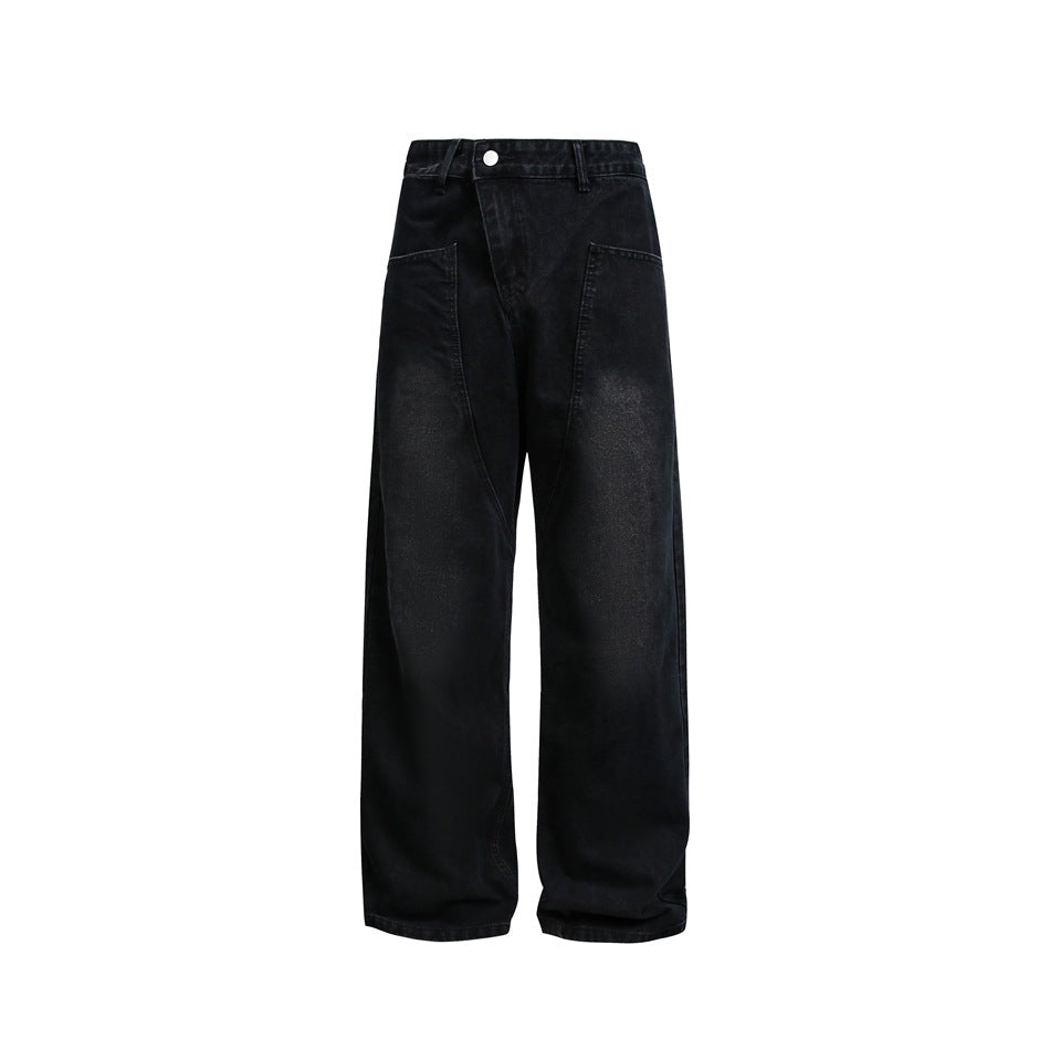 Washed black wide-leg jeans with diagonal waistband and curved front seams, flat front view