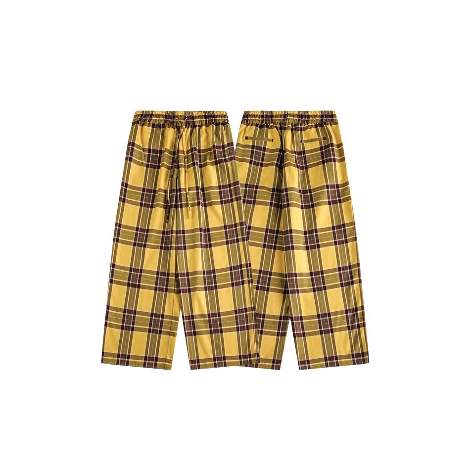 Mustard yellow plaid pants shown in front and back views, with an elastic waist and wide straight legs.