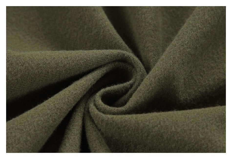 Close-up of dark olive plush fabric arranged in soft folds.