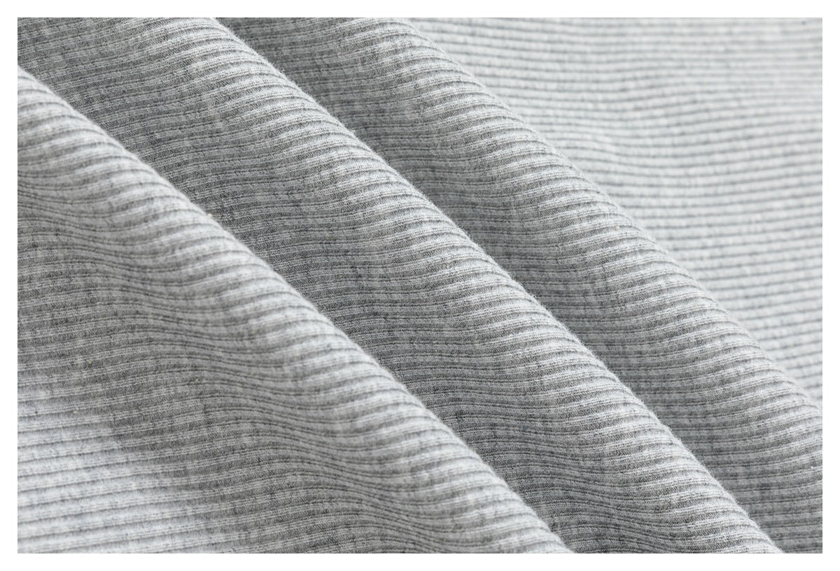 Close-up showing the fine horizontal ribbed texture of light gray knit fabric.