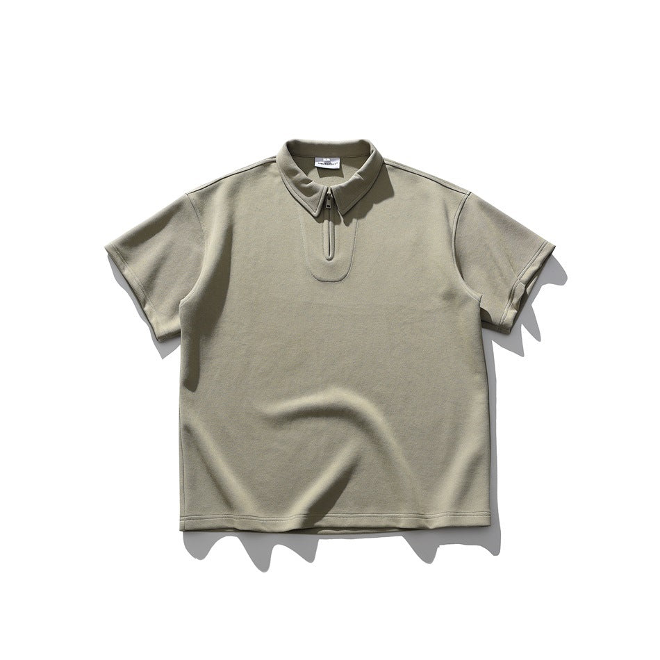 Sage green short-sleeve zip-neck polo-style top with pointed collar, laid flat, front view