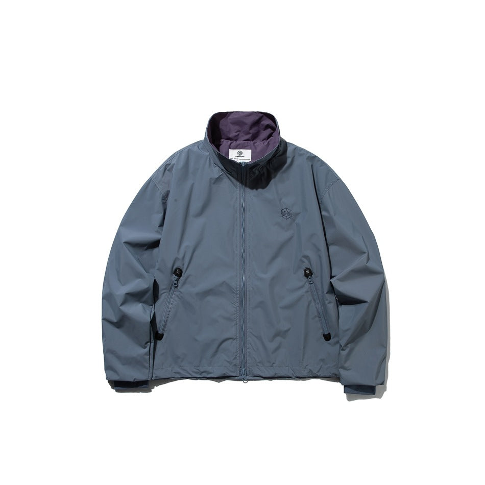 Haze blue stand-collar zip jacket flat lay with diagonal zip pockets, chest embroidery and purple inner collar