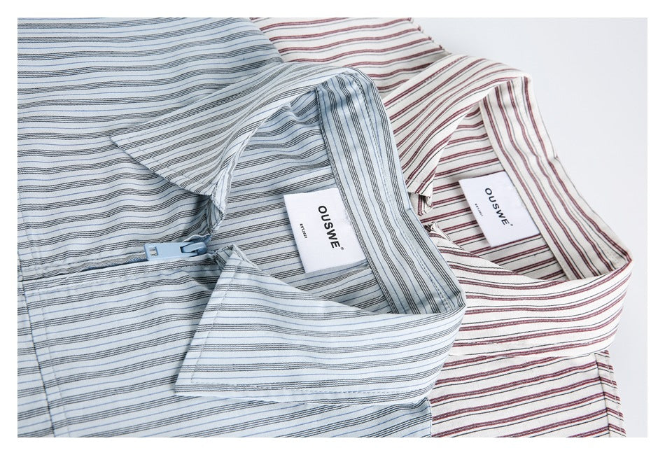 Close-up of blue-gray and burgundy striped shirts showing collars and sewn-in OUSWE labels.