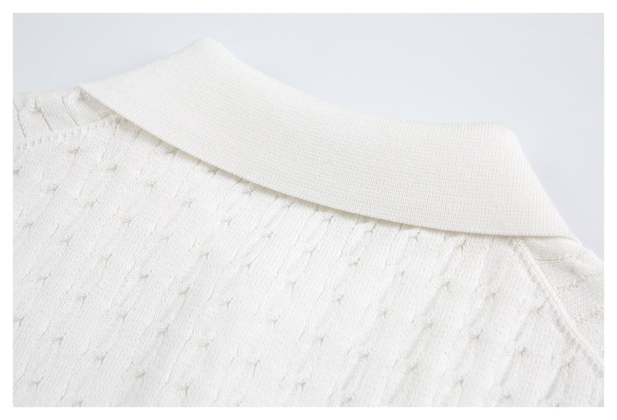 Close-up of the ivory knit garment's broad ribbed collar and textured upper body.