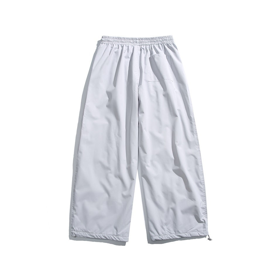 Back view of white wide-leg pants with an elastic waistband, one rear pocket and adjustable ankle hems.