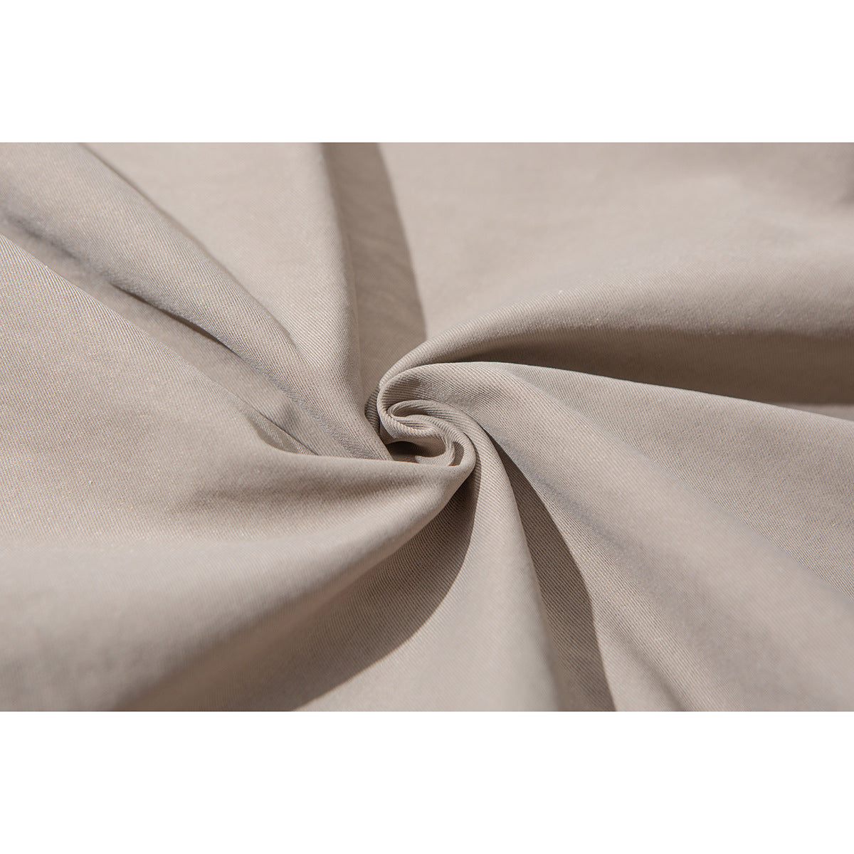 Close-up of taupe-colored fabric gathered into soft folds.