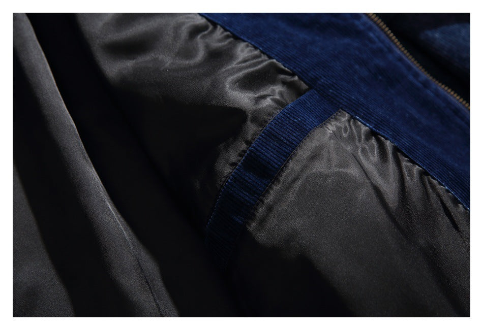 Close-up of black lining, navy ribbed trim, and a zipper on a garment.