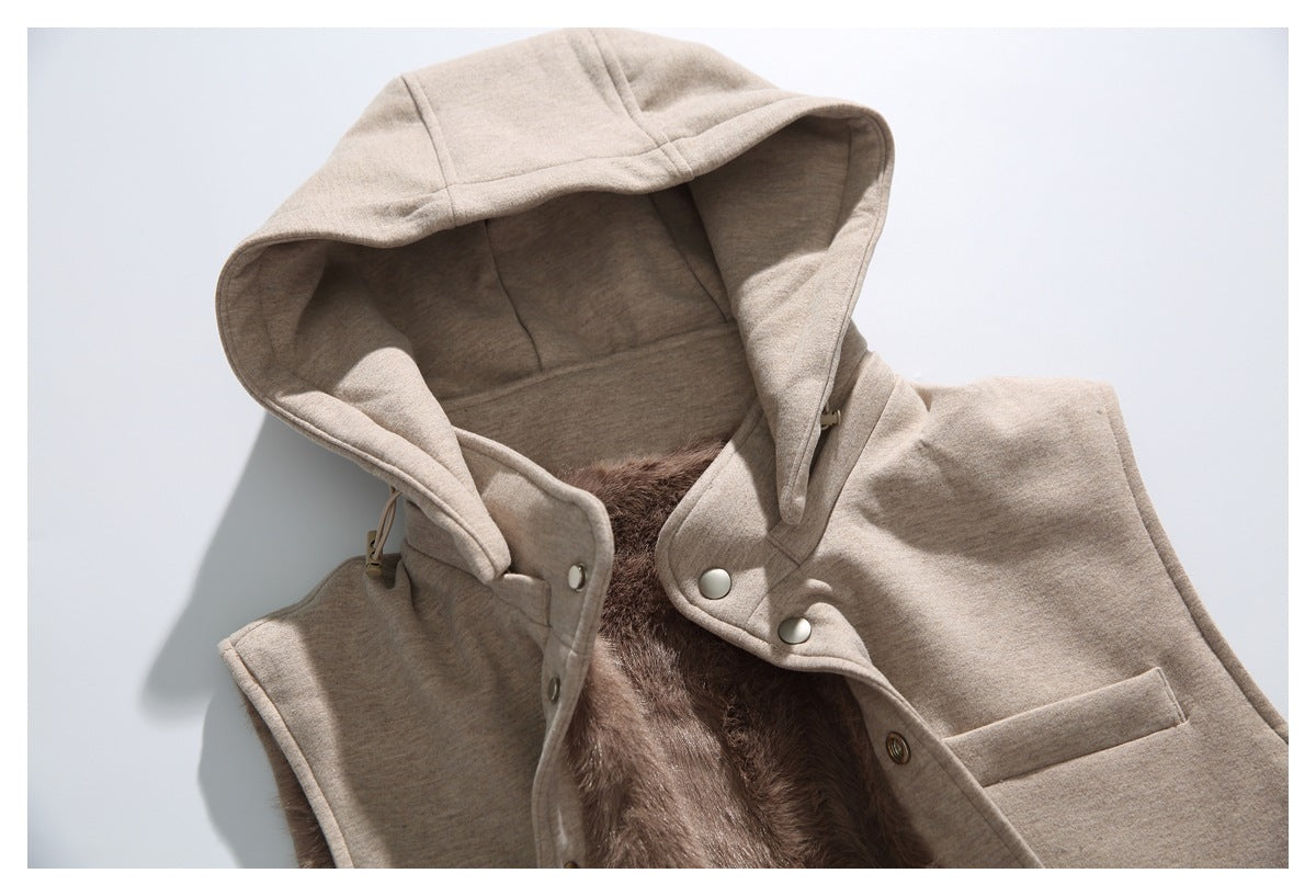 Close-up of the vest's large hood, snap-front opening and plush brown lining.