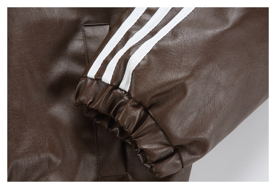 Close-up of a dark brown jacket sleeve with three white stripes and a gathered cuff.