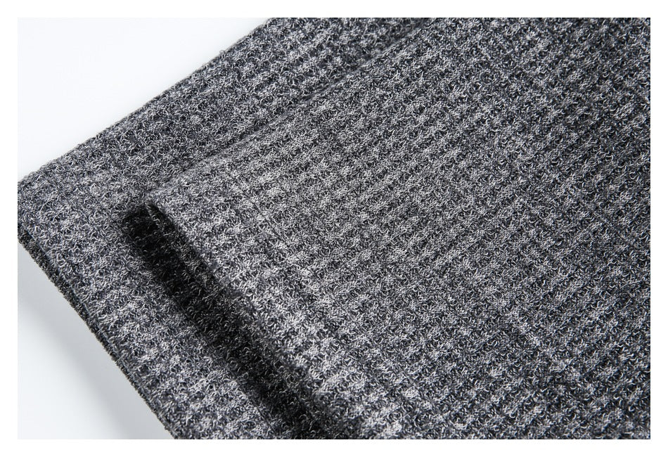 Close-up of the charcoal gray knit fabric and a folded garment edge.