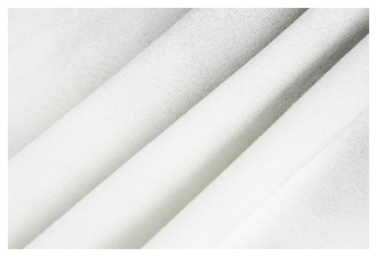 Macro view of off-white shirt fabric arranged in soft folds.