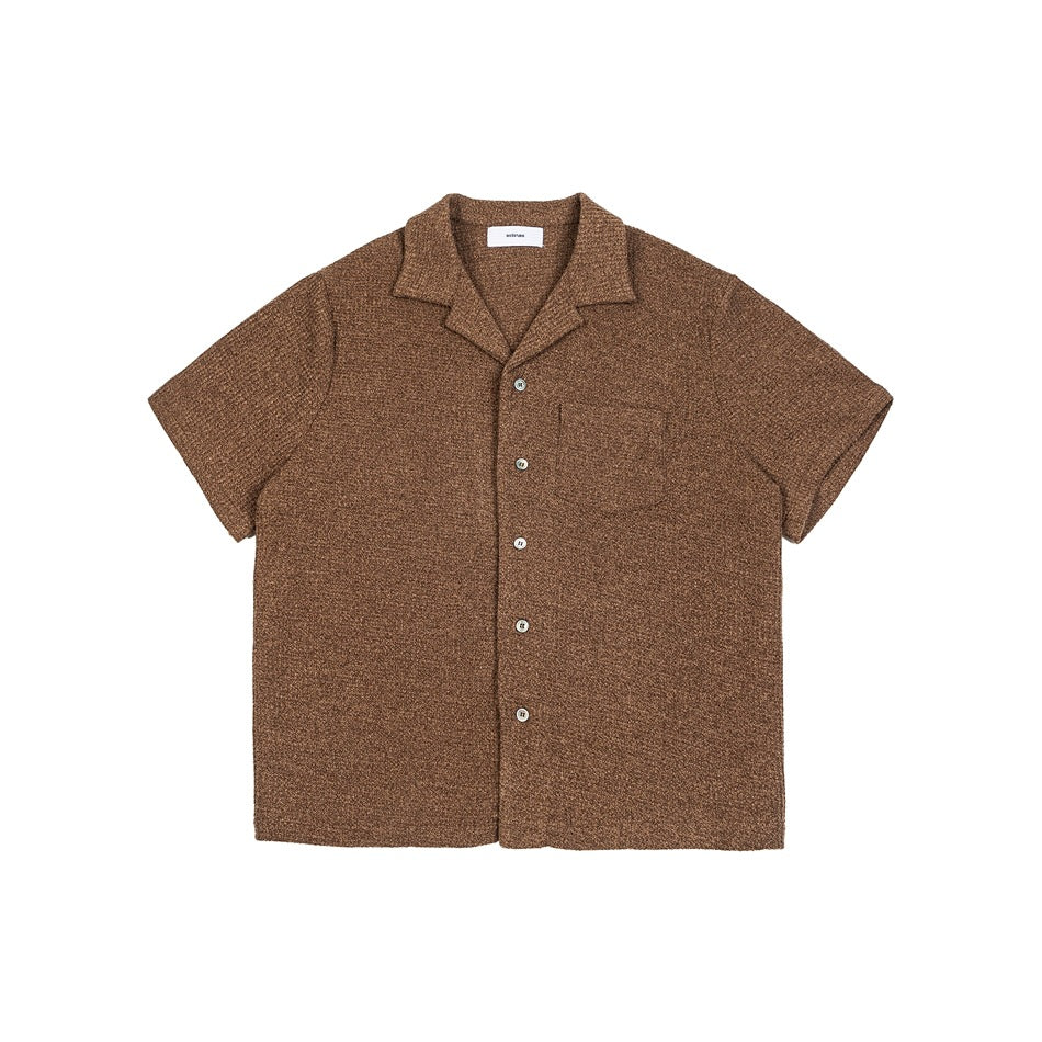 Front view of a brown short-sleeve knit shirt with a notched collar, button front, and chest pocket.