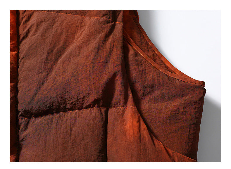 Close-up of the rust-orange garment's armhole edge, stitching, and side panels.