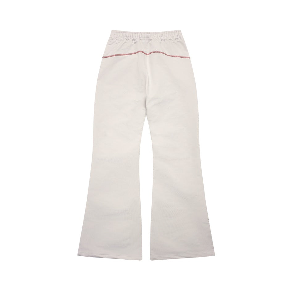 Full view of light gray flared trousers with an elastic waistband and a curved contrast seam across the back.