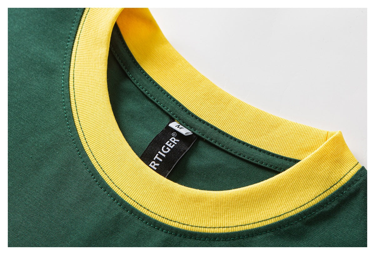 Close-up of a dark green shirt neckline with yellow ribbed trim and a visible black neck label.