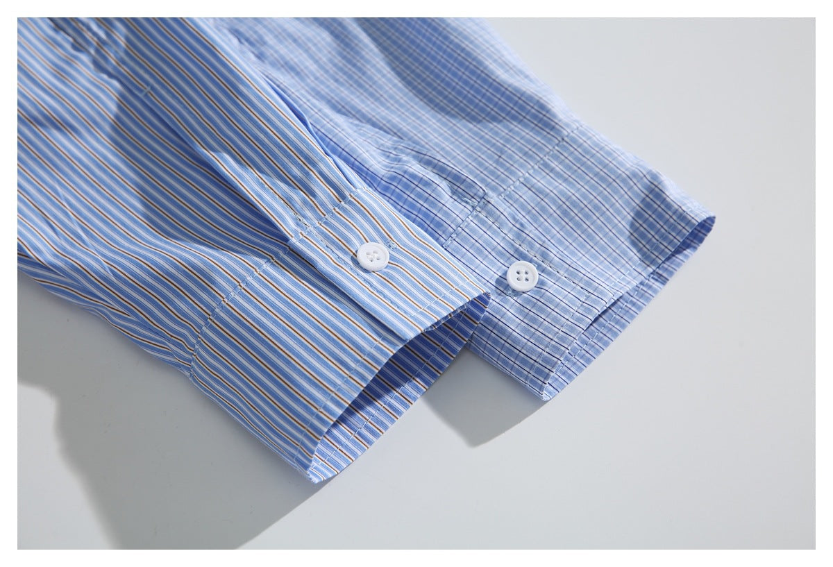 Close-up of the striped shirt cuff with a white button beside a pale blue checked cuff.