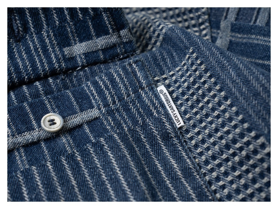 Close-up of a shirt button, patchwork fabric, and a small sewn-in brand tab.