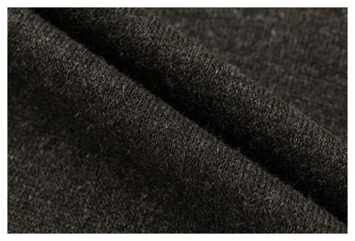 Macro view of the dark brown coat's thick, looped knit-like surface.