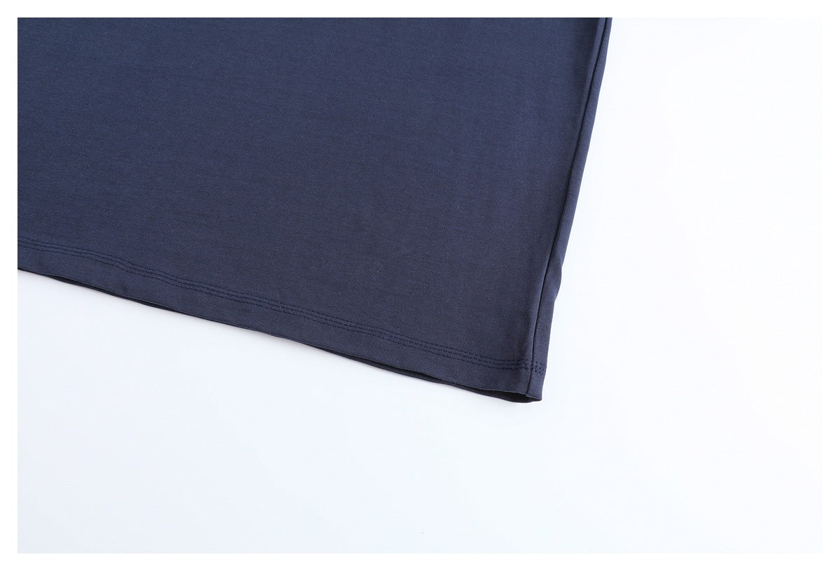 Close-up of the plain dark navy T-shirt body and its double-stitched lower hem.