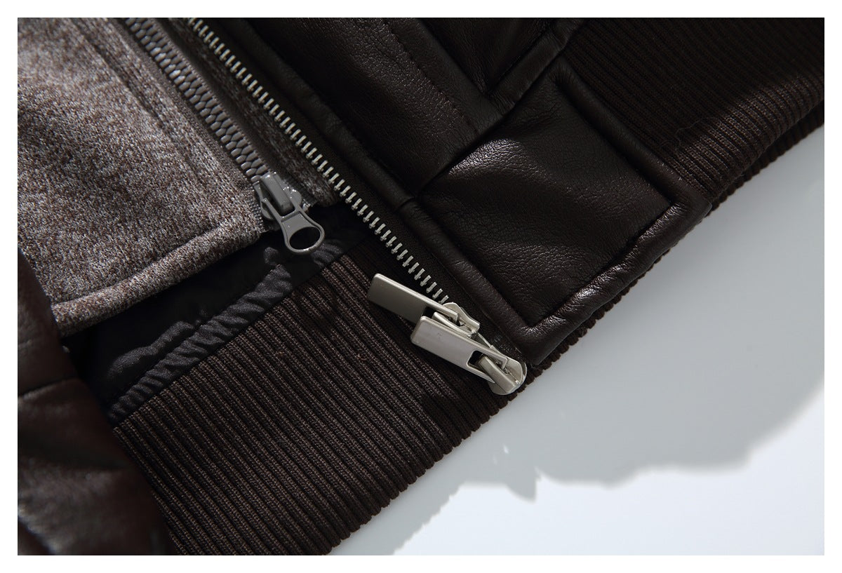 Close-up of a dark brown jacket’s ribbed hem, metal zipper pulls, and contrasting textured inner layer.