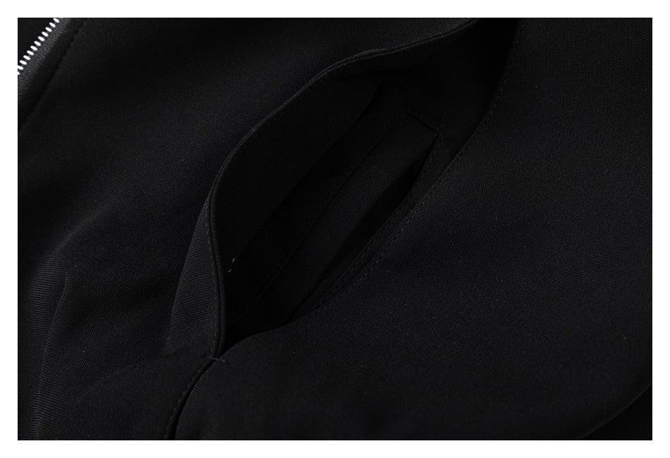 Close-up of a slanted pocket opening in black garment fabric.