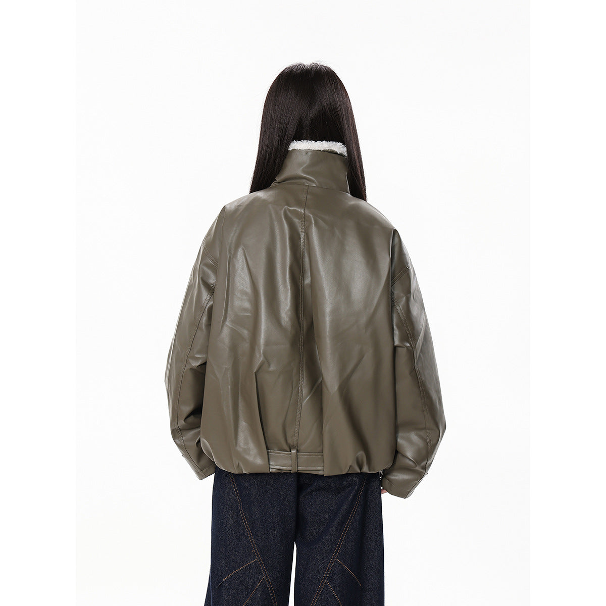 Back view of a model wearing an oversized olive-gray jacket with a high collar and gathered hem.