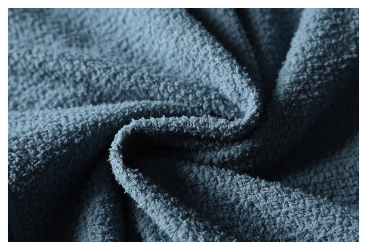 Close-up of plush blue fleece folded to show its thick, soft-looking texture and edge.