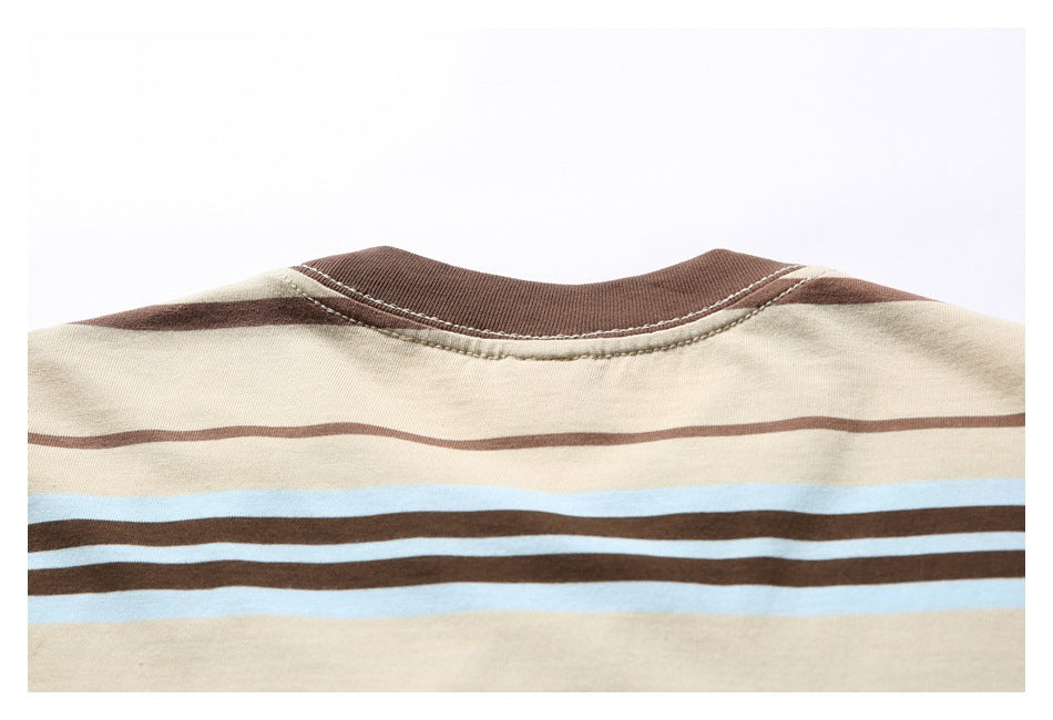 Upper back view of a beige T-shirt with a brown ribbed collar and horizontal brown and pale blue stripes.