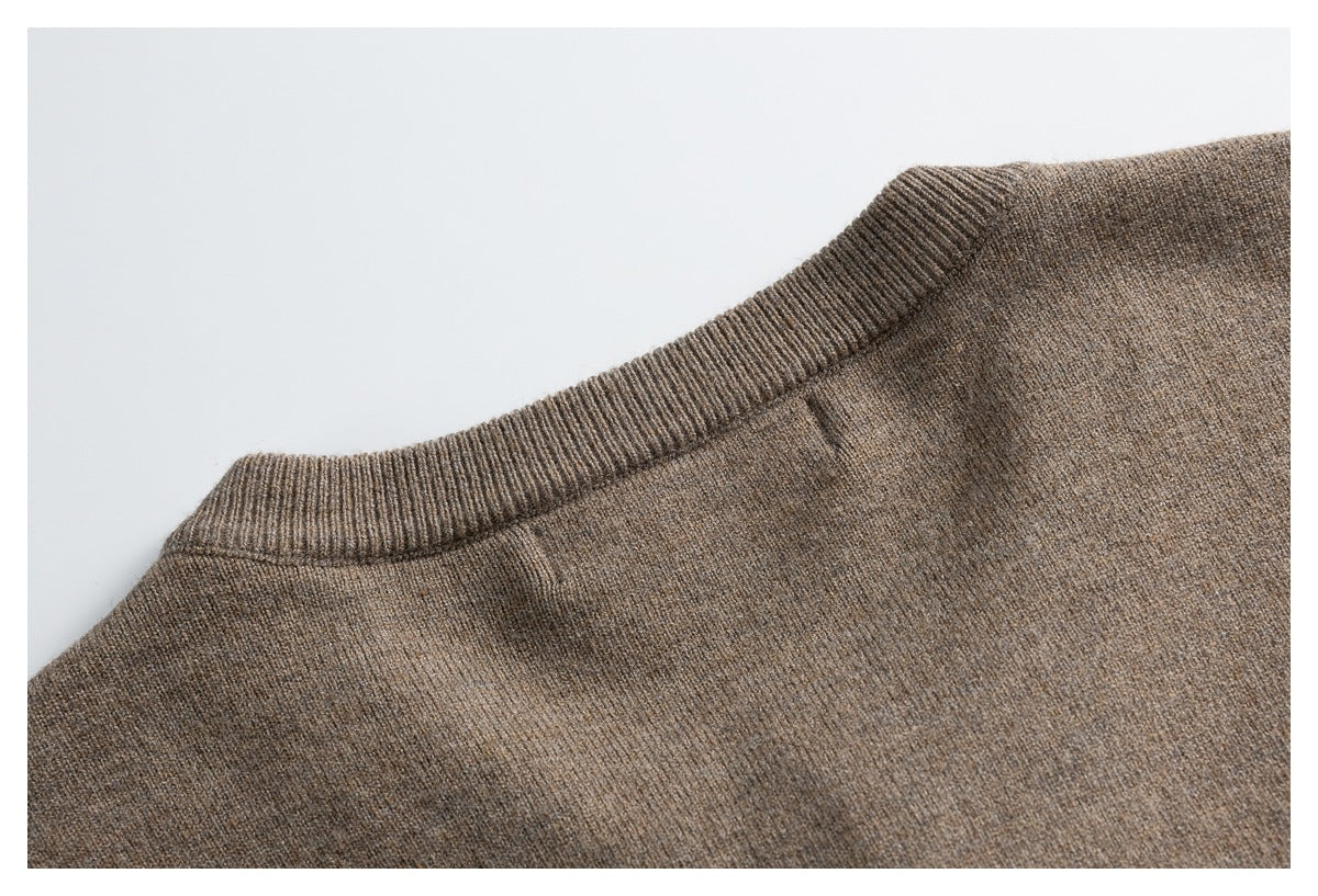 Close-up of the taupe cardigan's ribbed crew neckline and shoulder seam.
