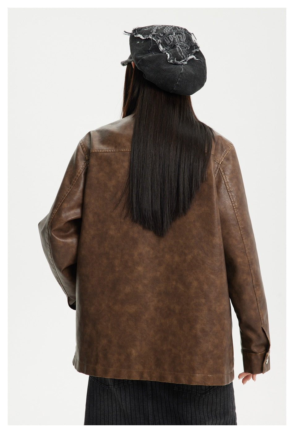 Back view of a model wearing a brown mottled-finish jacket with seam detailing and a straight hem.