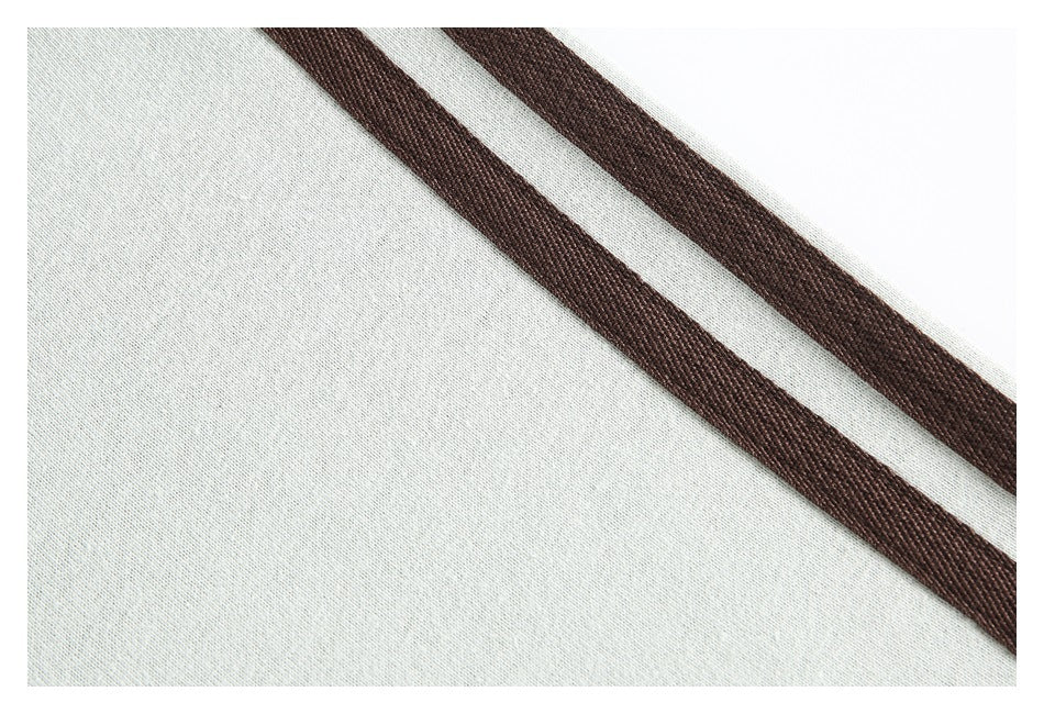 Close-up of a pale gray garment with two dark brown parallel stripes.