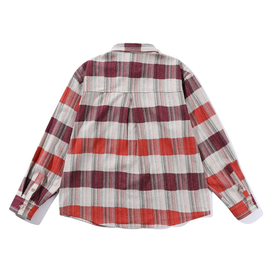 Back view of a long-sleeve shirt in red, burgundy and cream plaid, with a center back pleat.