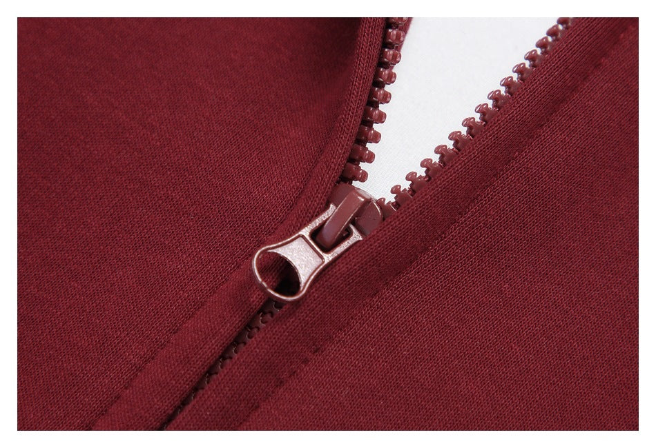 Close-up of a burgundy hoodie’s front zipper and matching zipper pull.