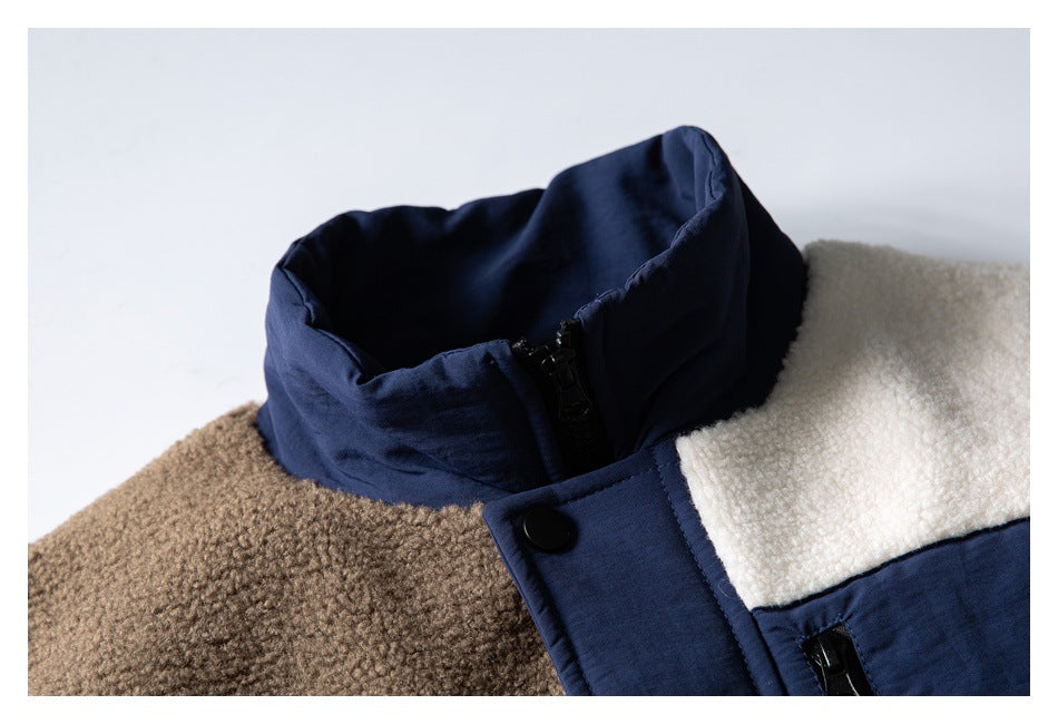Close-up of the jacket's navy stand collar, snap placket, and cream and brown fleece panels.