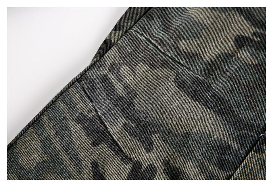 Close-up of dark gray and olive camouflage fabric with a diagonal stitched seam.
