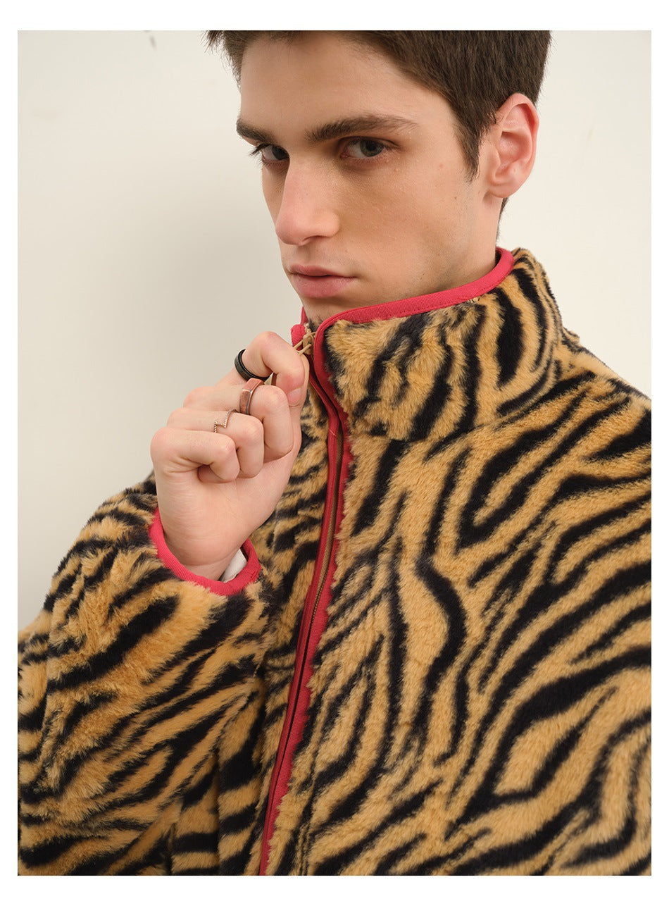 Close-up of a model in a tiger-stripe plush jacket showing stand collar, red zipper tape and red cuff trim