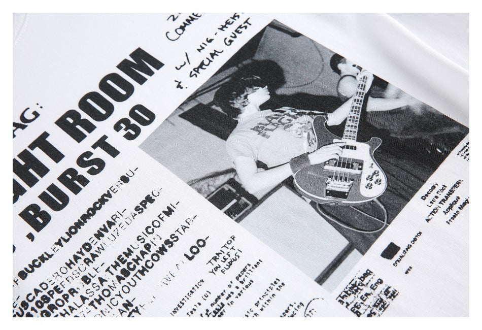 Close-up of a white T-shirt graphic featuring bold black lettering and a monochrome image of a bassist.