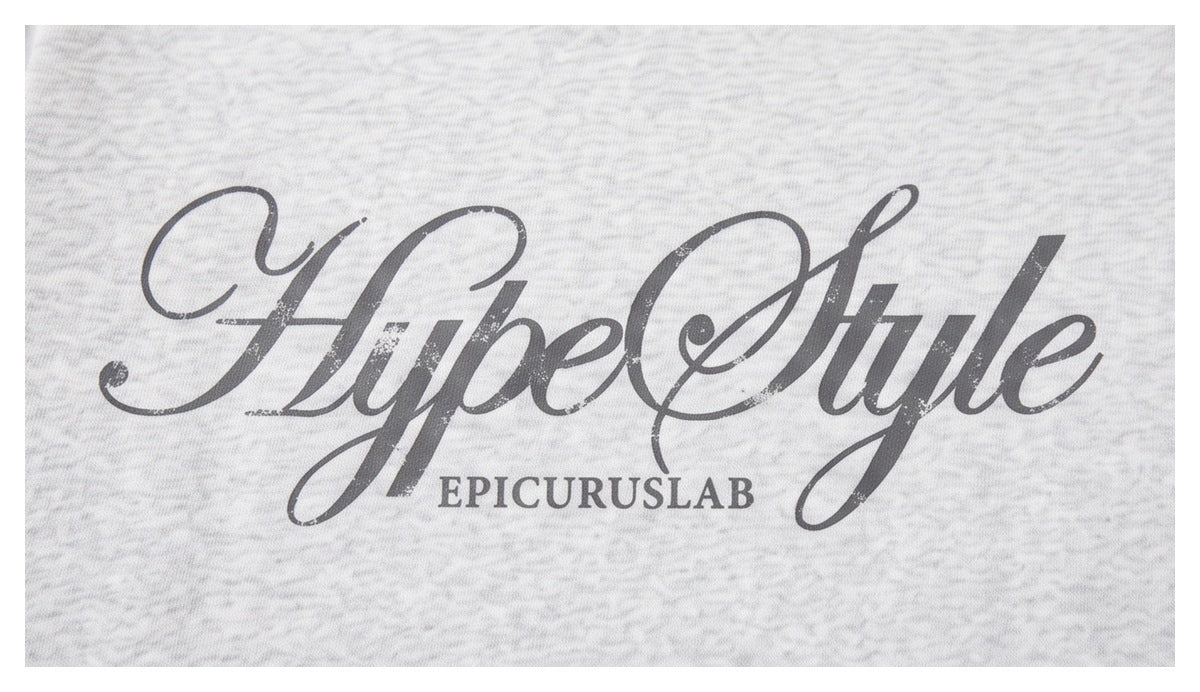Close-up of a light gray marled garment printed with a large dark “HypeStyle” script graphic and “EPICURUSLAB” below.