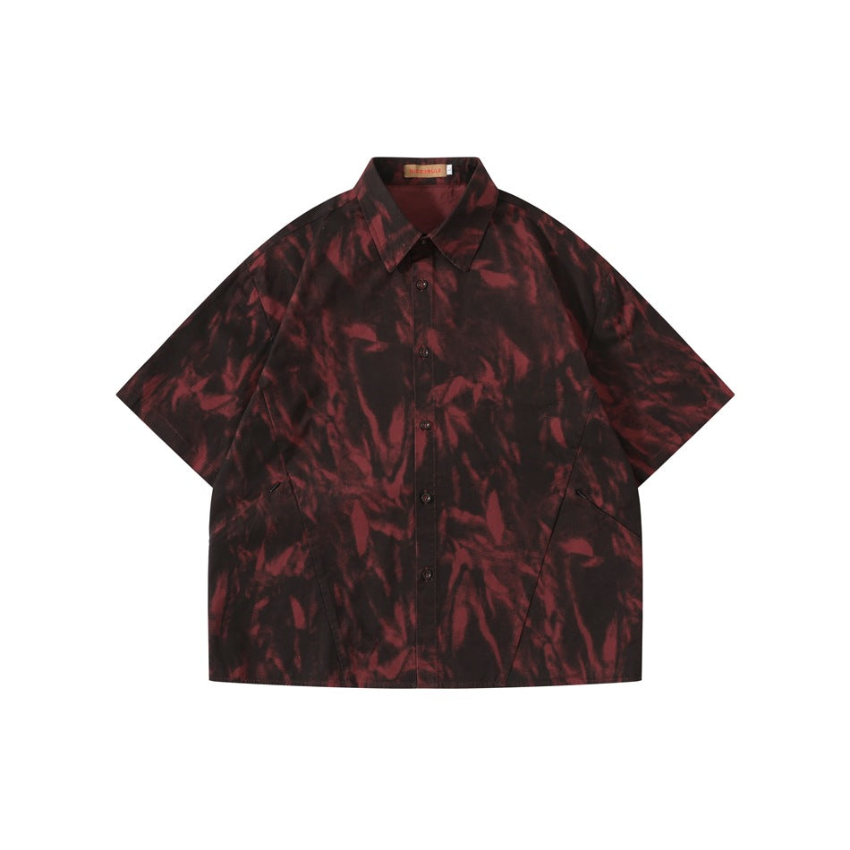 Dark red and black tie-dye style short-sleeve button-up shirt, flat front view